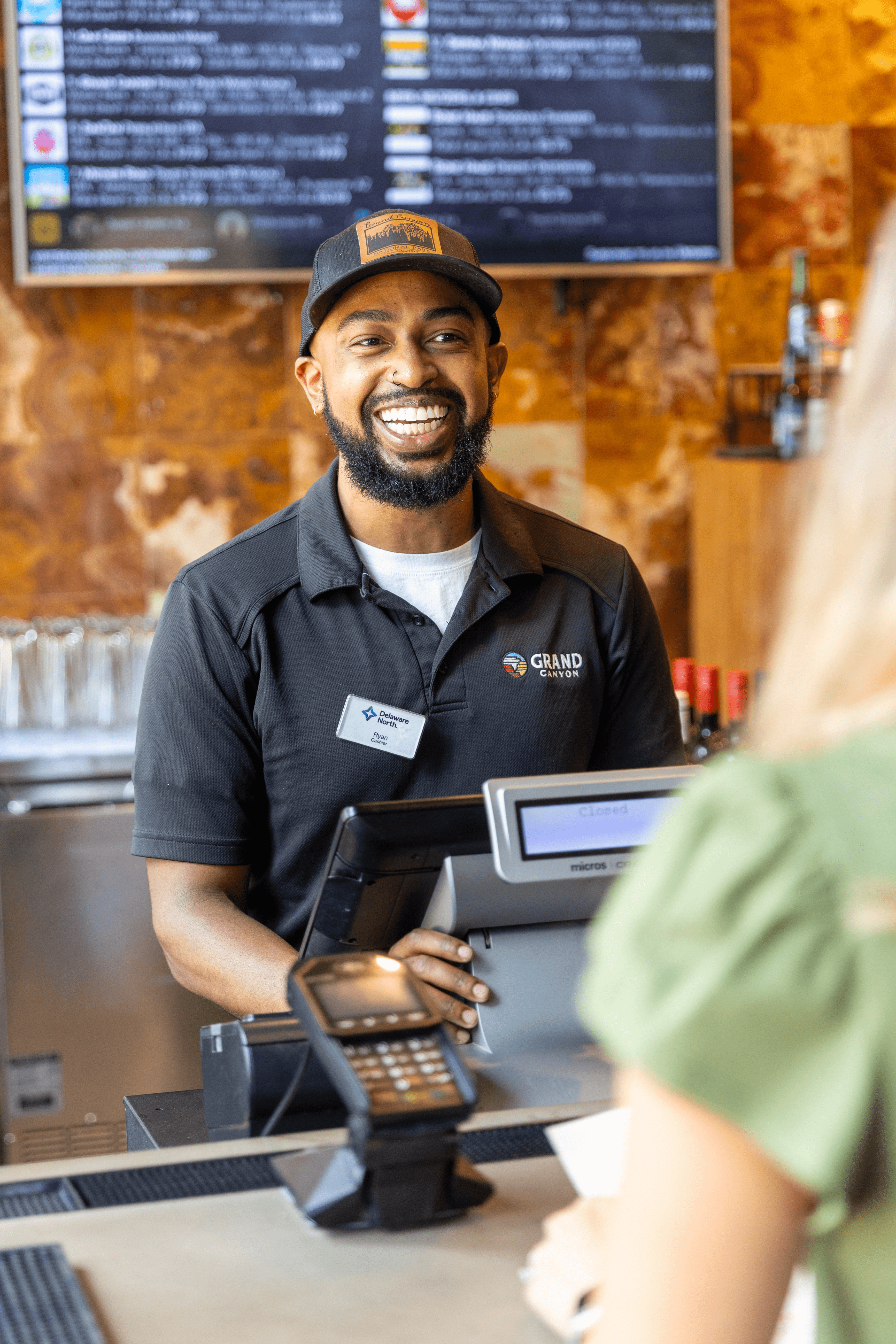 Grand Canyon cashier team member smiling at guest