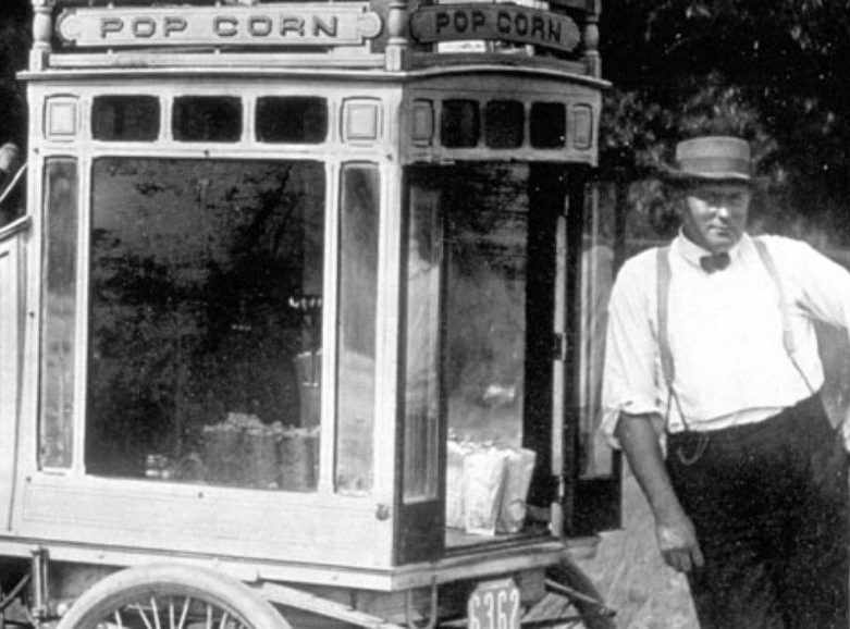 1915_Jacobs brother leaning on popcorn stand
